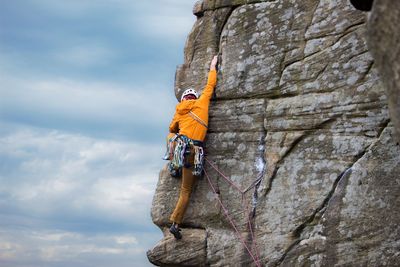 Rear view of man climbing on rock