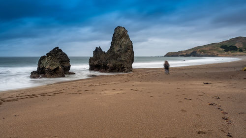 Rocks on beach against sky