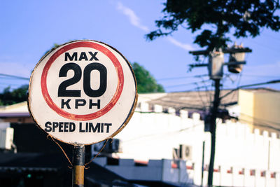 Speed limit sign against building