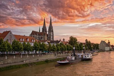 Boats in river with city in background