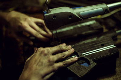 Cropped image of worker working on machinery