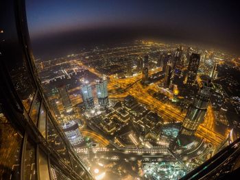 Aerial view of city lit up at night