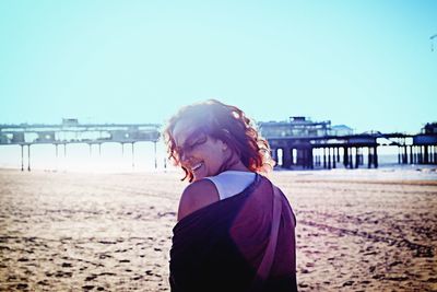 Full length of woman standing on beach