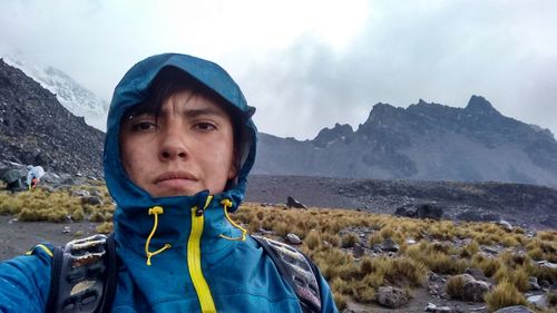 High angle view of woman standing on mountain