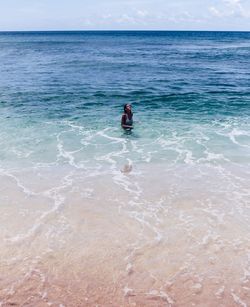 Person in sea against sky