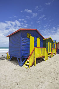 Beach hut against blue sky