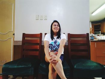 Happy young woman sitting on chair