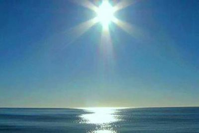 Sun shining over sea