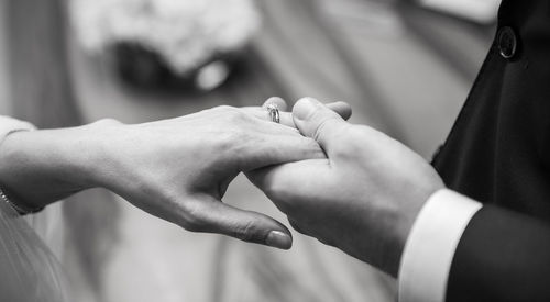 Midsection of couple holding hands