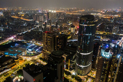 High angle view of city lit up at night