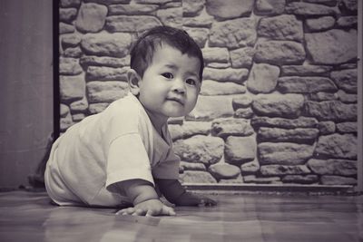 Portrait of cute boy girl sitting on floor at home