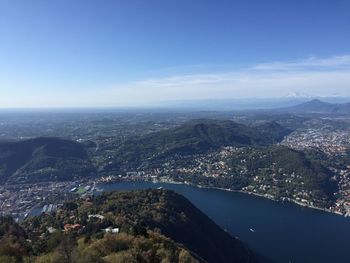 Aerial view of city by sea against sky