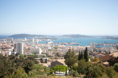 High angle view of townscape by sea against sky