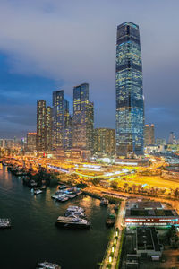 Illuminated buildings in city against sky