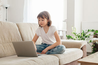 Girl using laptop at home