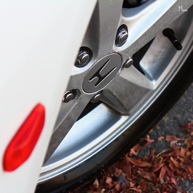 transportation, mode of transport, close-up, car, land vehicle, part of, indoors, high angle view, no people, metal, cropped, reflection, red, glass - material, day, shiny, still life, selective focus, stationary, vehicle part