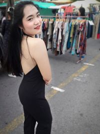 Portrait of smiling young woman standing outdoors