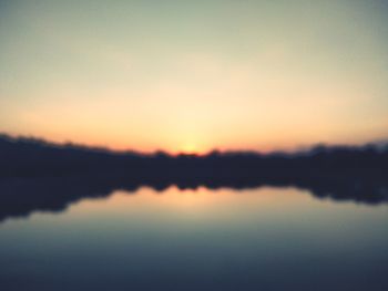 Scenic view of lake against romantic sky at sunset