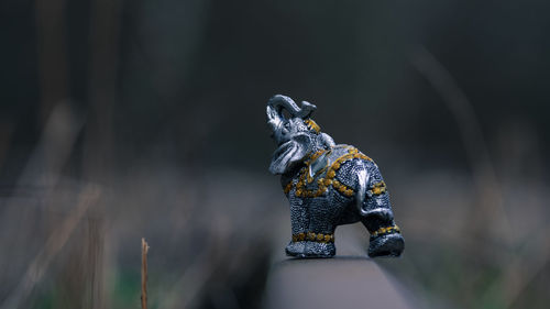 Close-up of elephant figurine on field