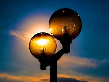 Low angle view of street light against sky at sunset