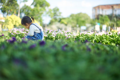 Rear view of little girl on field