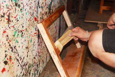 High angle view of hand holding painting at home