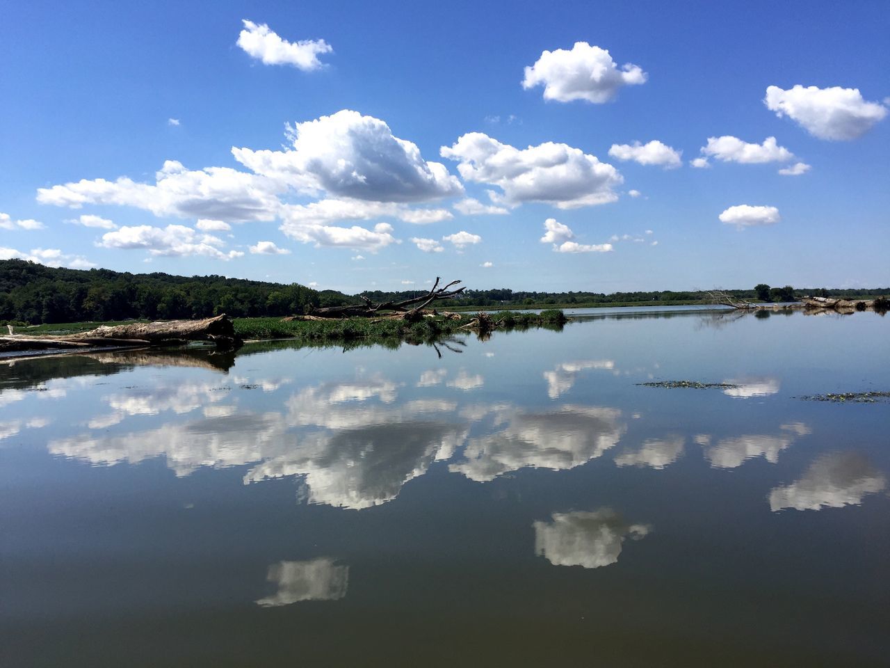 reflection, water, sky, tranquil scene, scenics, tranquility, cloud - sky, lake, blue, beauty in nature, cloud, waterfront, nature, idyllic, standing water, non-urban scene, travel destinations, tourism, calm, vacations, day, majestic, no people, countryside, cumulus cloud