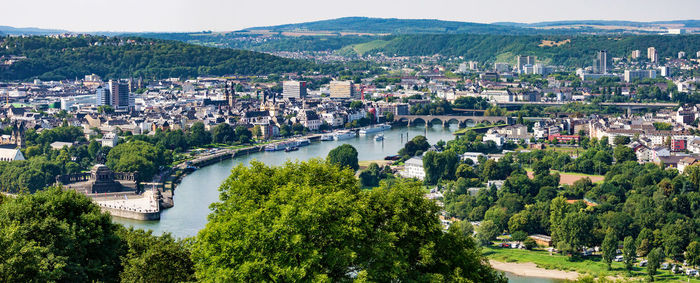 High angle view of river and cityscape against sky