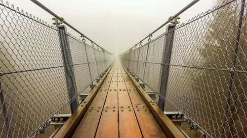 View of empty bridge during foggy weather