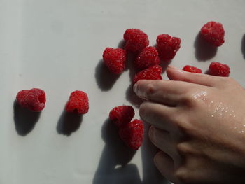 Midsection of woman holding strawberries