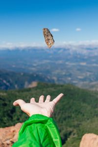 Midsection of person paragliding against sky