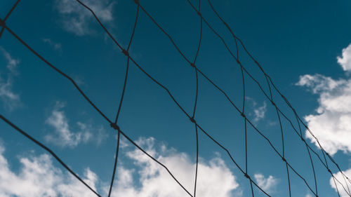 Low angle view of cables against blue sky