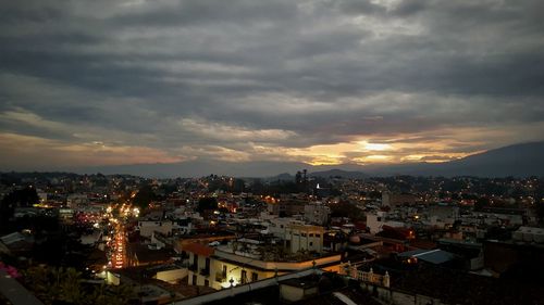 Cityscape against cloudy sky