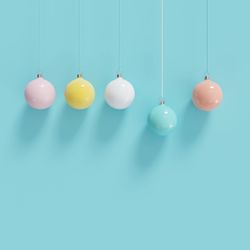 Close-up of bauble hanging against blue background