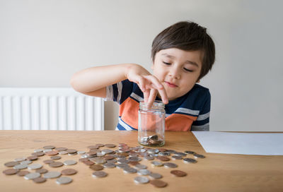 Portrait of boy with hands on table