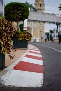 Close-up of road by building in city