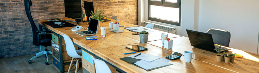 Interior of industrial style coworking office with various workplaces