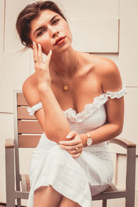 Beautiful young woman sitting at home