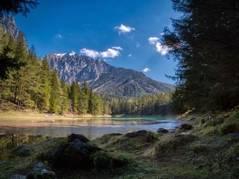 Scenic view of lake and mountains against sky