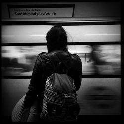 Woman standing on railroad track