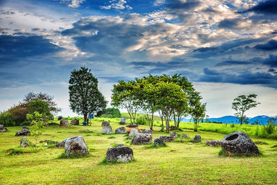 Hay bales on field against sky