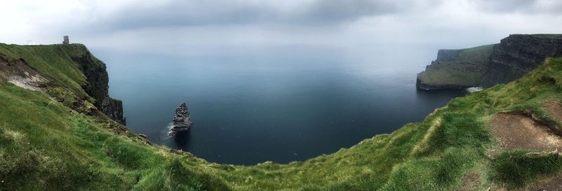 Scenic view of mountains against cloudy sky