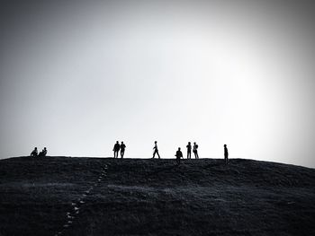 Woman on landscape against clear sky