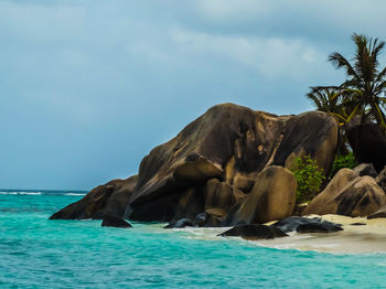 Scenic view of rocks in sea against sky