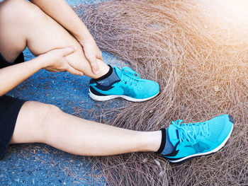 Low section of woman sitting on blue floor