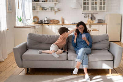 Woman sitting on sofa at home