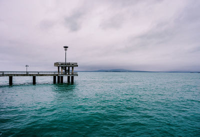 Pier over sea against sky