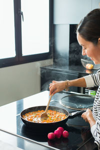 Boy preparing food in kitchen