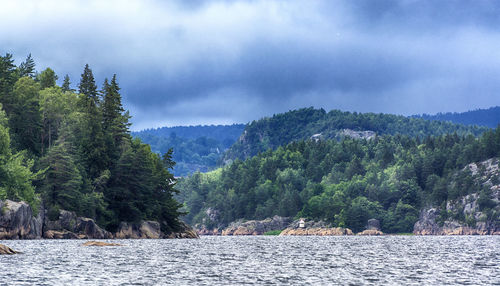 Scenic view of lake against cloudy sky