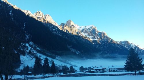 Scenic view of snow covered mountains against sky